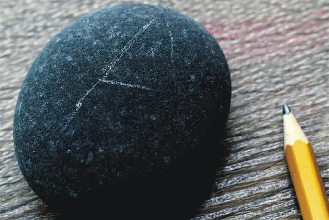 Marking a Stone with Pencil